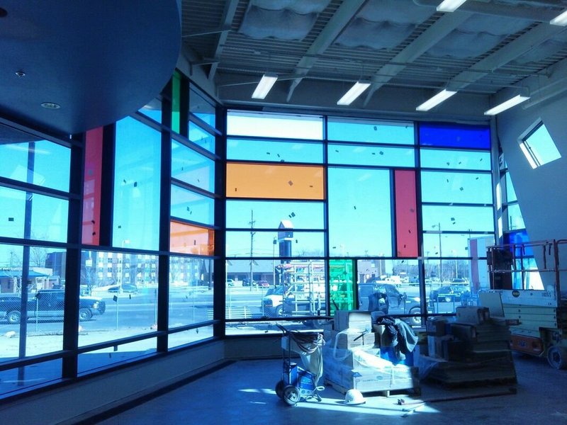 Colorful commercial storefront glass panel installation