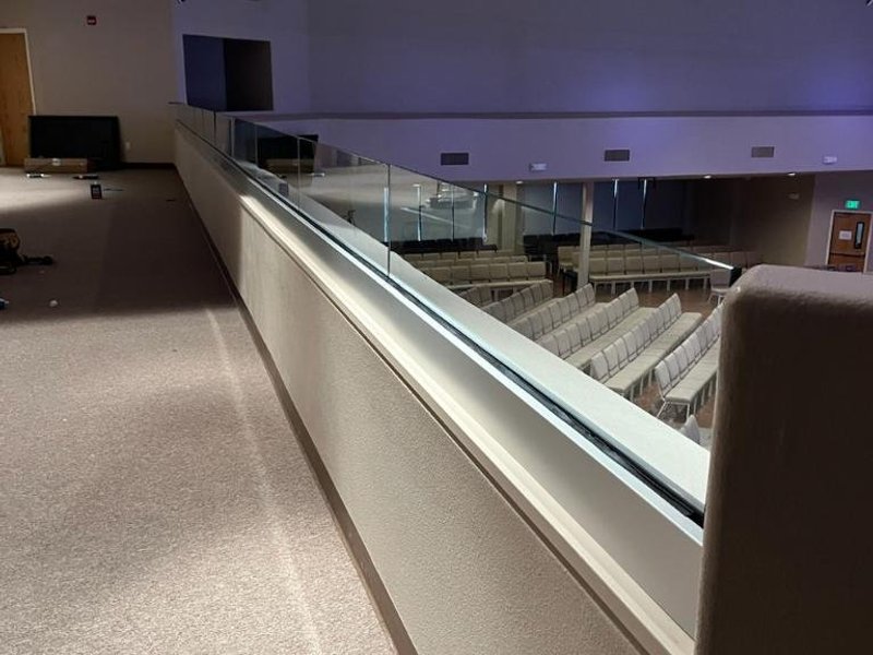 Commercial glass balcony railing divider for fall protection by Kent Glass