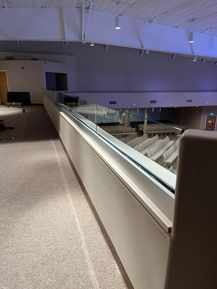 Commercial glass balcony railing divider for fall protection by Kent Glass
