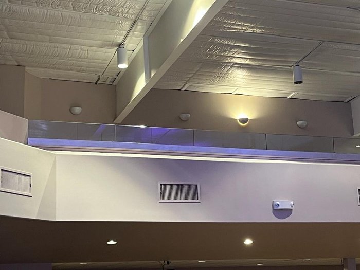 Commercial glass mezzanine railing with fall protection by Kent Glass