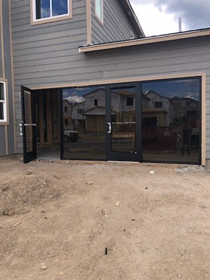 Commercial aluminum storefront with matte black framing on a new construction build by Kent Glass