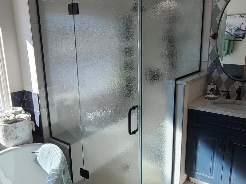 Frameless rain glass shower enclosure with matte black hardware