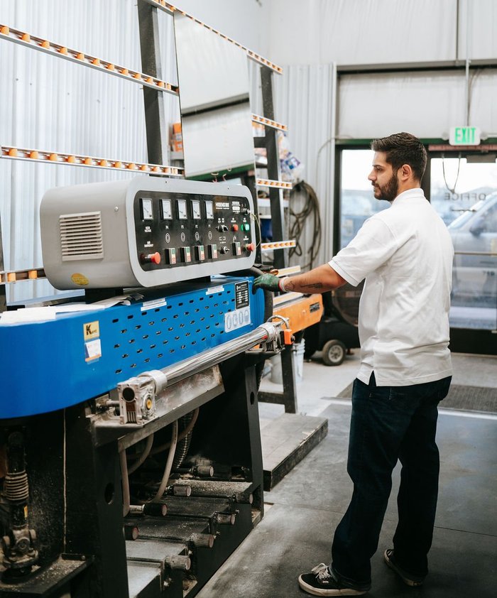 Kent Glass technician operating a glass fabrication machine